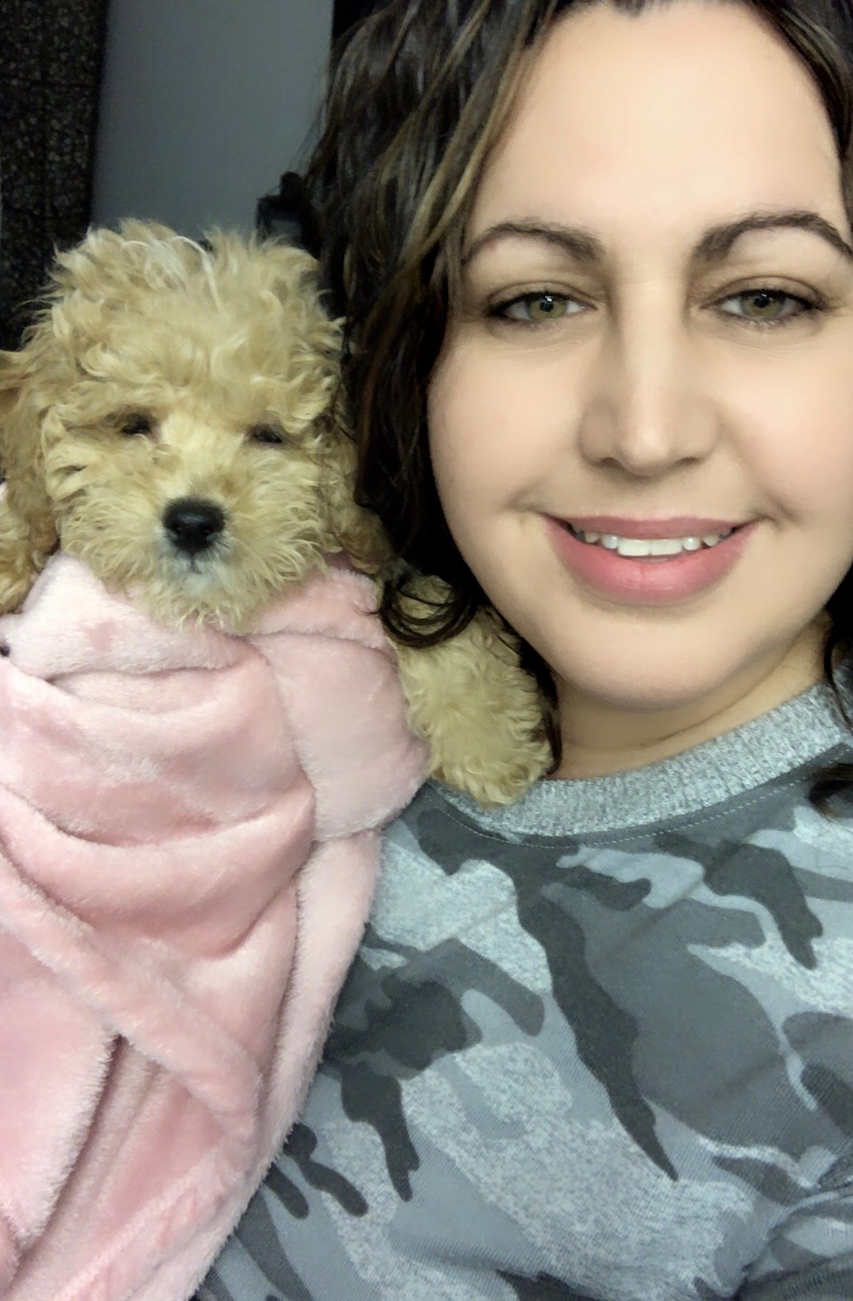 Ariella holding Muppy as a puppy